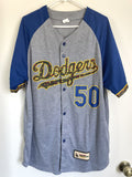 A gray and blue Los Angeles Dodgers baseball jersey with 'Dodgers' script and the number '50' on the front, hanging on a white hanger against a white wall.